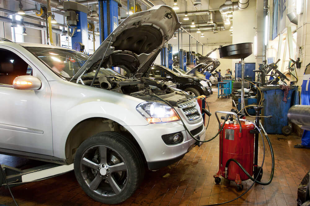 How can auto shops lower their workers' comp risk? 